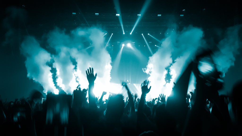 happy people dance in nightclub party concert